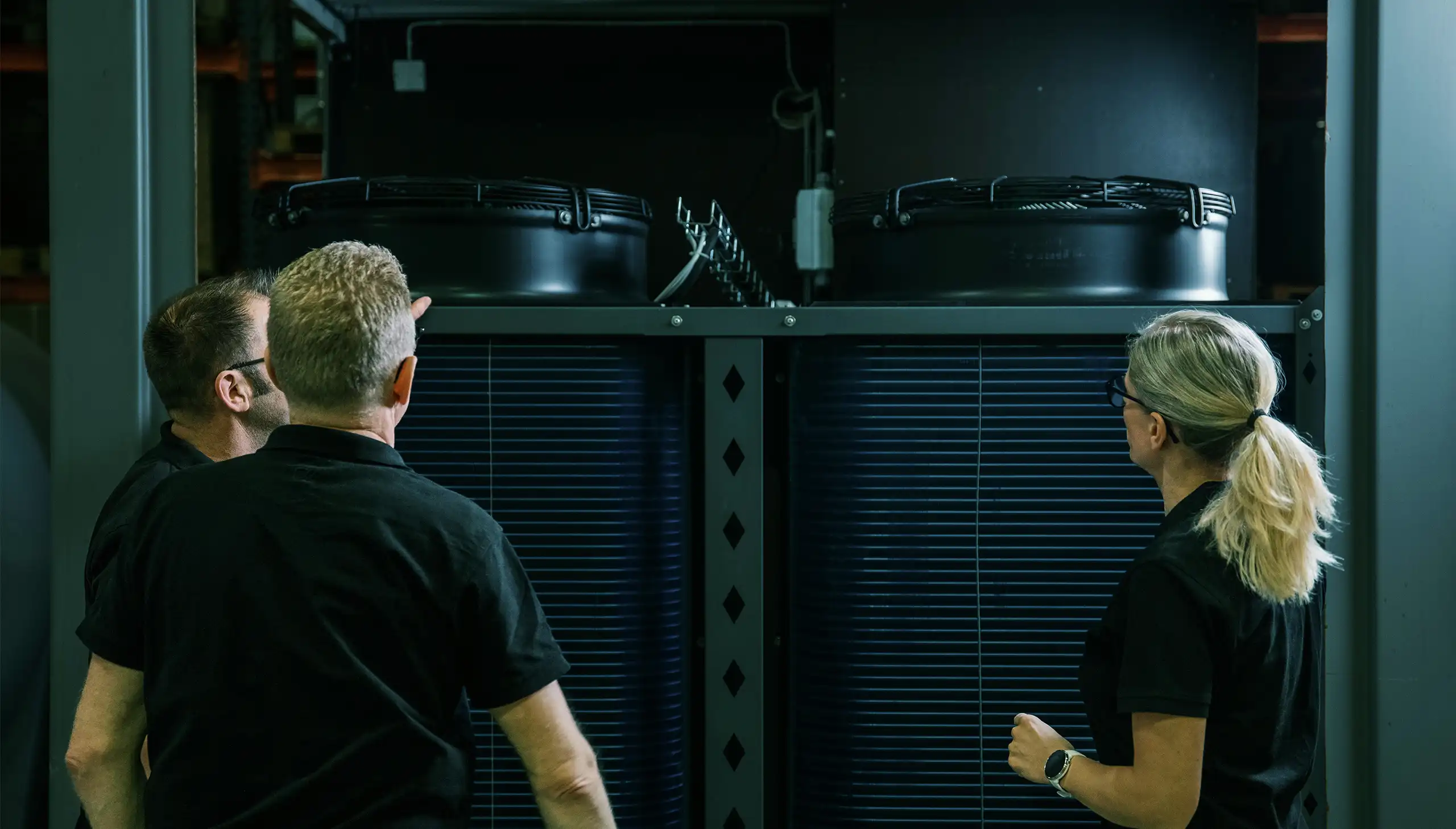 Professional partners inspecting a commercial heat pump installation.